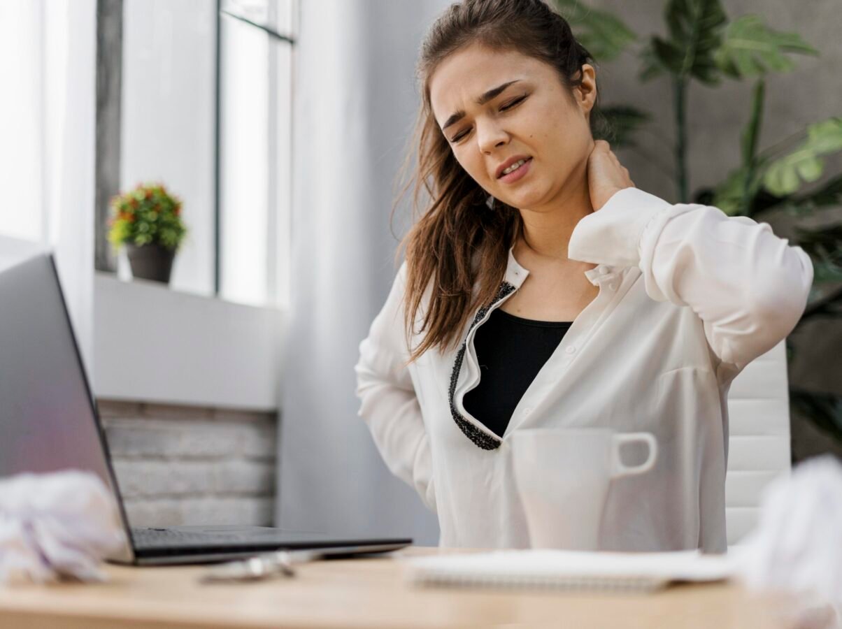 woman-having-neckache-while-working-home