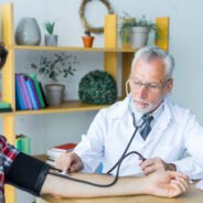 doctor-measuring-blood-pressure-young-patient