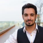 Young handsome Indian man at rooftop restaurant in Bangkok Thailand